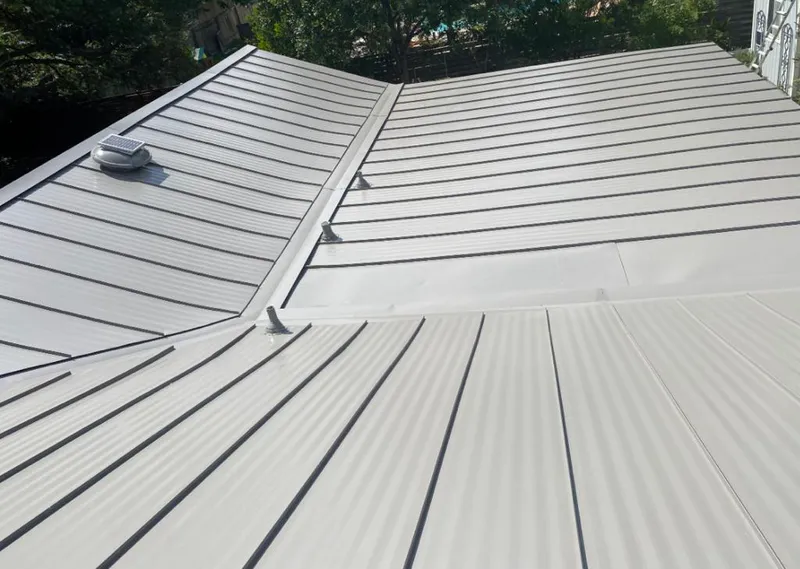 Solar attic fan installed on a metal roof for Roof Ventilation in Collingdale