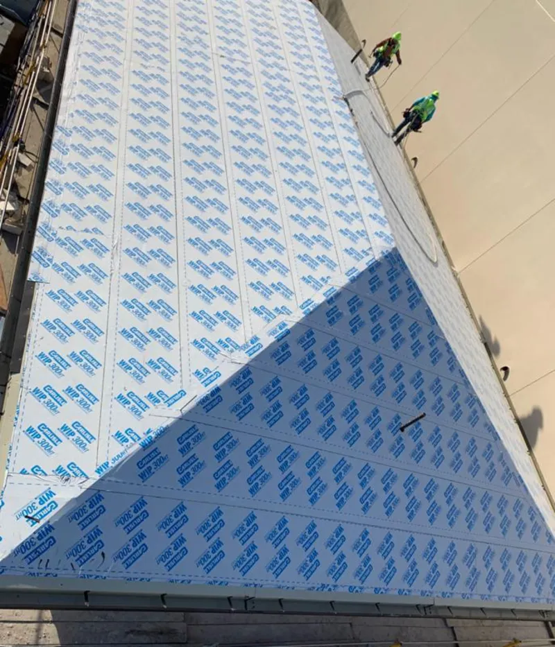 Professional roofers installing underlayment on a metal roof in Collingdale